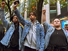 Activists stand in solidarity following the conviction of the cop who murdered Laquan McDonald